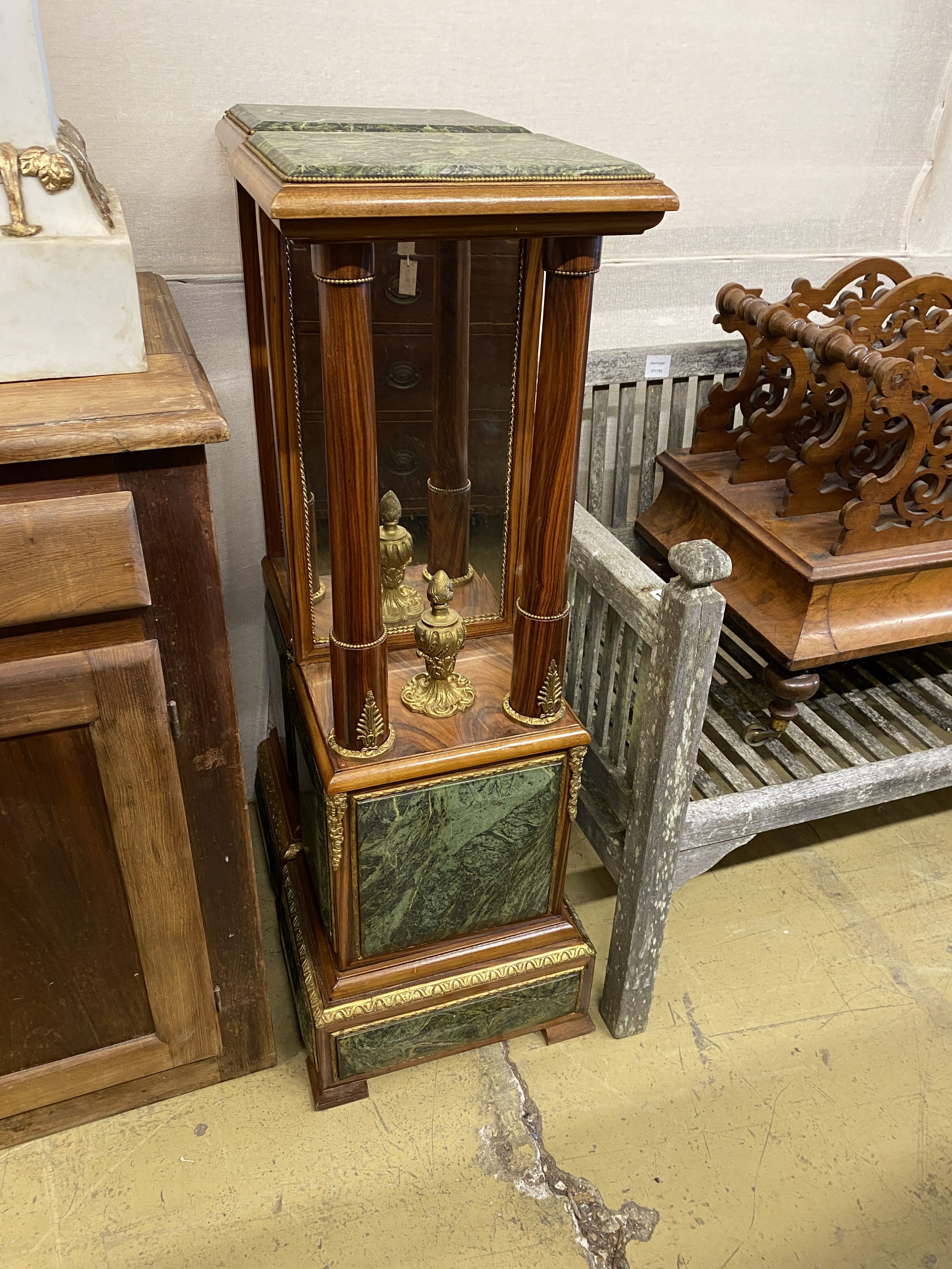 A pair of Empire style gilt metal mounted walnut mirrored pier tables, width 34cm, depth 24cm, height 109cm